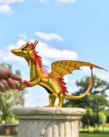 Scale image of gold Wyrmling sculpture