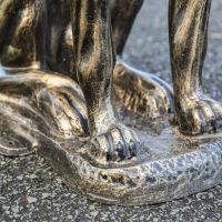 Close-Up of Feet and Sculpture Base