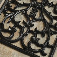 Close up of scroll detailing on doormat 