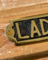 Close Up of Solid Brass Ladies Sign 
