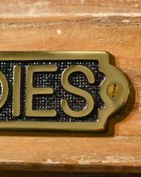 Close Up of Solid Brass Ladies Sign 