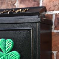 Close up of Black Post Box with Green Clover Motif 