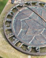 Close Up of Aged Iron Frog Sundial 
