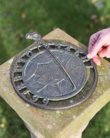 Scale Shot of Aged Iron Frog Sundial 