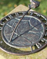 Close Up of Aged Iron Frog Sundial 