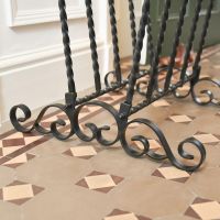 Close up of scroll work on Wrought Iron Welly Rack 