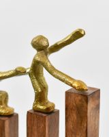 Close up of gold cast aluminium figure on interior art sculpture