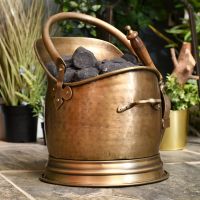 Beautiful antique bronze coal scuttle in living room