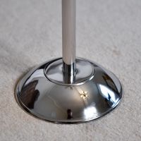Close up of circular polished steel companion set base 