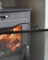 Close up of handle on top of black fire guard