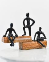 Angled view of black figure on mango wood base interior ornament