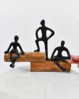 Scale image of black cast aluminium and mango wood interior ornament