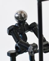 Close up of intricate figure detail on scrap metal art sculpture