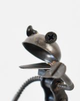 Close up of intricate frog detail on scrap metal art sculpture
