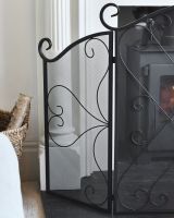 Close up of ornate detailing on decorative black fire guard