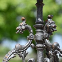 Close up of Aged Black "Serpent" Cast Iron Side Table