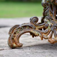 Close up of rustic vintage gothic cast iron side table feet