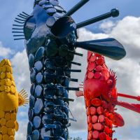 Close up of metal colourful giraffe heads with ears 