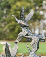 Close up of Flock of Flying Ducks Garden Sculpture 
