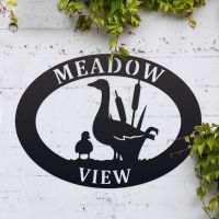 Goose & Gosling Iron Oval House Sign on a White Wall