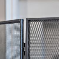 Close up of black finish on three fold fire guard 