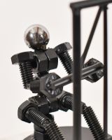 Close up of intricate figure detail in scrap metal art sculpture