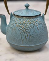 Close up of gold detailing on side of "Hami" Light Blue Cast Iron Japanese Style Teapot
