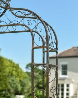 Close up of ornate scrollwork detail on rose arch