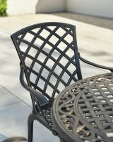 Close up of lattice metalwork detail on patio dining set