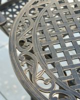 close up of intricate lattice table detail on patio table and chairs set
