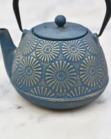 Close up of embossed sunflower detailing on "Himawari" Blue and Gold Cast Iron Japanese Style Teapot 