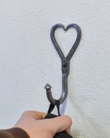 Scale image of heart detail coat hook