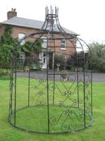 Black Gazebo in front of town house with support bars