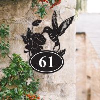 Bespoke Hummingbird Iron House Number Sign on a Garden Wall