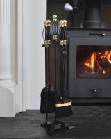In situ photo of black fireside companion set with brass detailing