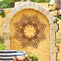 Mandela Wall Art in Situ on a Yellow Garden Wall