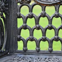 Close up of decorative ornate detailing on garden bench 