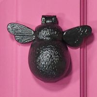 Iron Bumblebee Door Knocker on a Pink Door