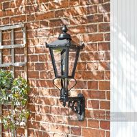 Lantern on royal bracket mounted on brick wall