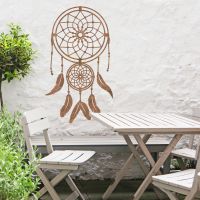 Dream Catcher Steel Wall Art in Situ in the Garden by a Wooden Furniture Set