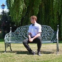 Large Rustic "Artemis" Ornate Bench With Gentleman Sitting