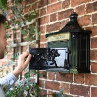 Black Post box mounted on wall with door open