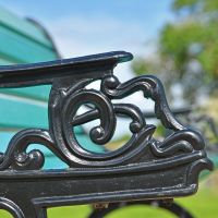 Close up of cast iron ornate arm rest detailing 