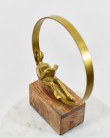 Top view of person reading aluminium gold sculpture
