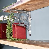 "Lotus Flower" Bright Chrome Wall Bracket Holding up a Wooden Shelf