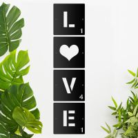 "LOVE" Scrabble Square Letters on a Cream Wall