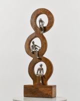 Angled view of cast aluminium and mango wood home decor sculpture