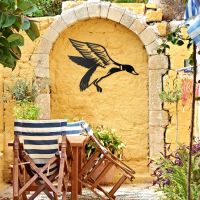 "Mallard" Duck Wall Art on a Yellow Wall in the Garden