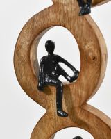 Close up of middle figure on cast aluminium and mango wood home decor sculpture