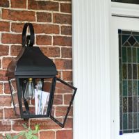 Midnight Black Flush Wall Lantern With Scrolled Bracket In Porch Setting